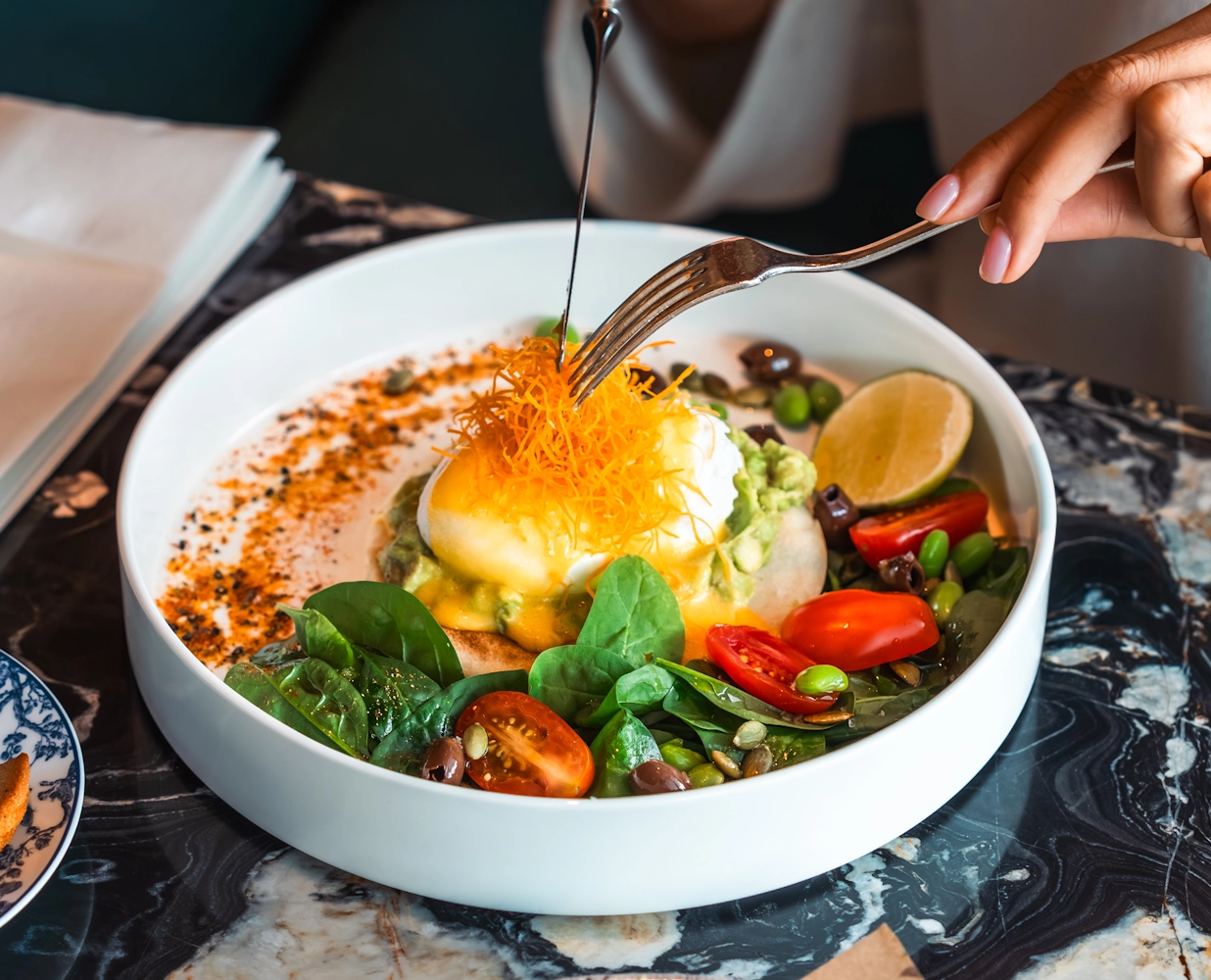 Best restaurants in Dubai Mall Breakfast dish with eggs and vegetables at Blume Restaurant Dubai